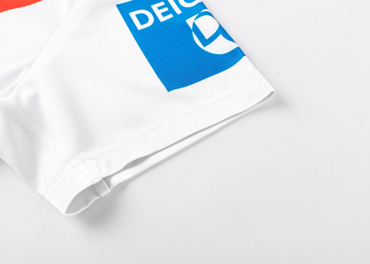 Zoom into the Dragons NRL 25/26 Replica Home Jersey by Classic Sportswear, a white classic adorned with blue and red logos, highlighted by "DEICH" in blue on the corner fabric—a tribute to Dragons NRL spirit.
