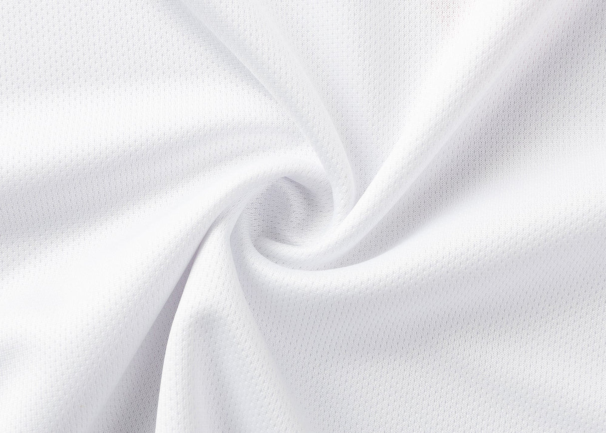 Close-up of Dragons NRL 25/26 Replica Home Jersey by Classic Sportswear, white fabric with a textured, perforated pattern reminiscent of classic sportswear, arranged in a spiral fold.