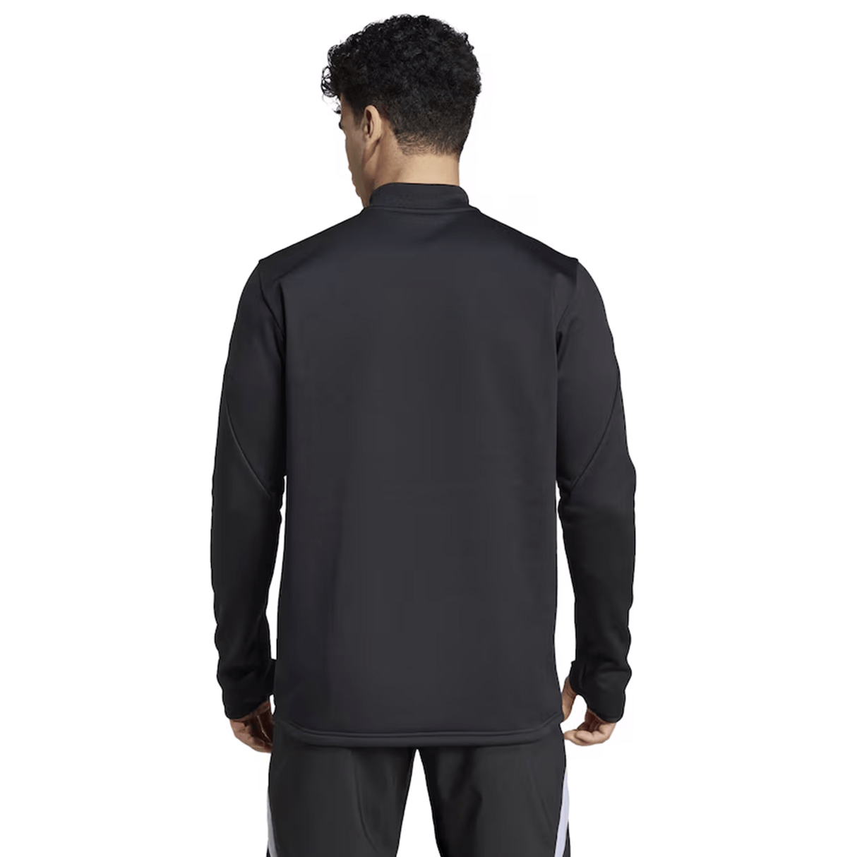 A person is seen from the back wearing the adidas All Blacks 24/25 Fleece 1/4 Zip, a long-sleeve black rugby top, paired with black pants featuring white stripes.