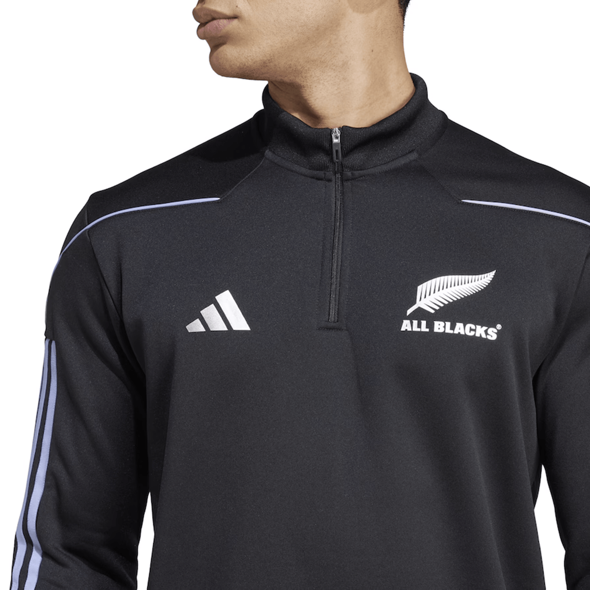 A person is wearing the adidas All Blacks 24/25 Fleece 1/4 Zip, featuring AEROREADY tech, black color with signature white sleeve stripes.