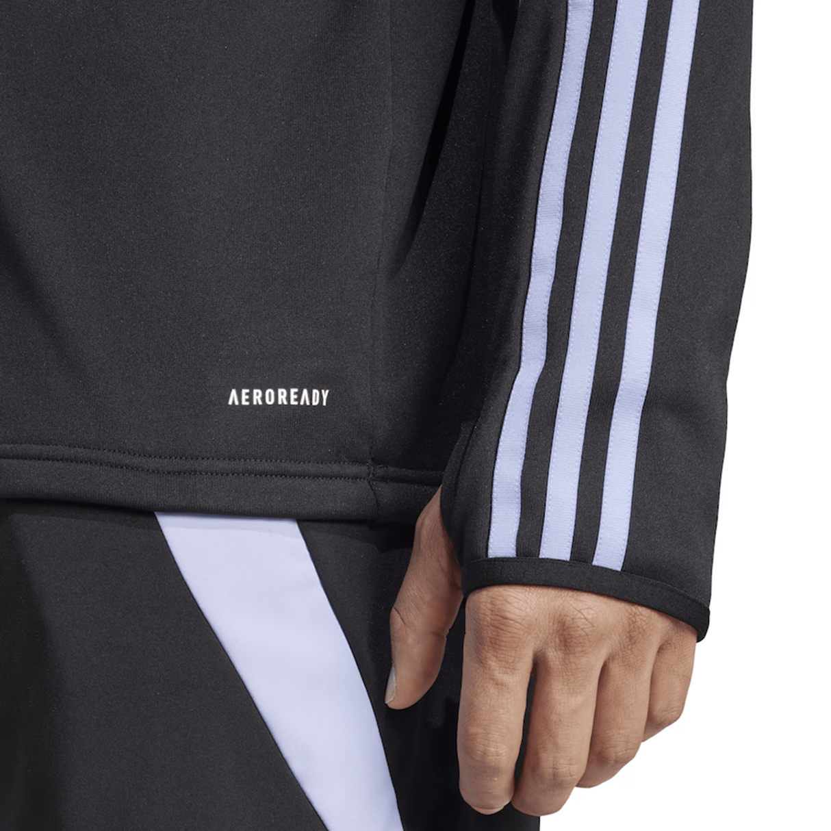 Close-up of a person wearing the adidas All Blacks 24/25 Fleece 1/4 Zip, a black athletic top with white stripes and AEROREADY moisture management technology, featuring "AEROREADY" printed on the shirt.