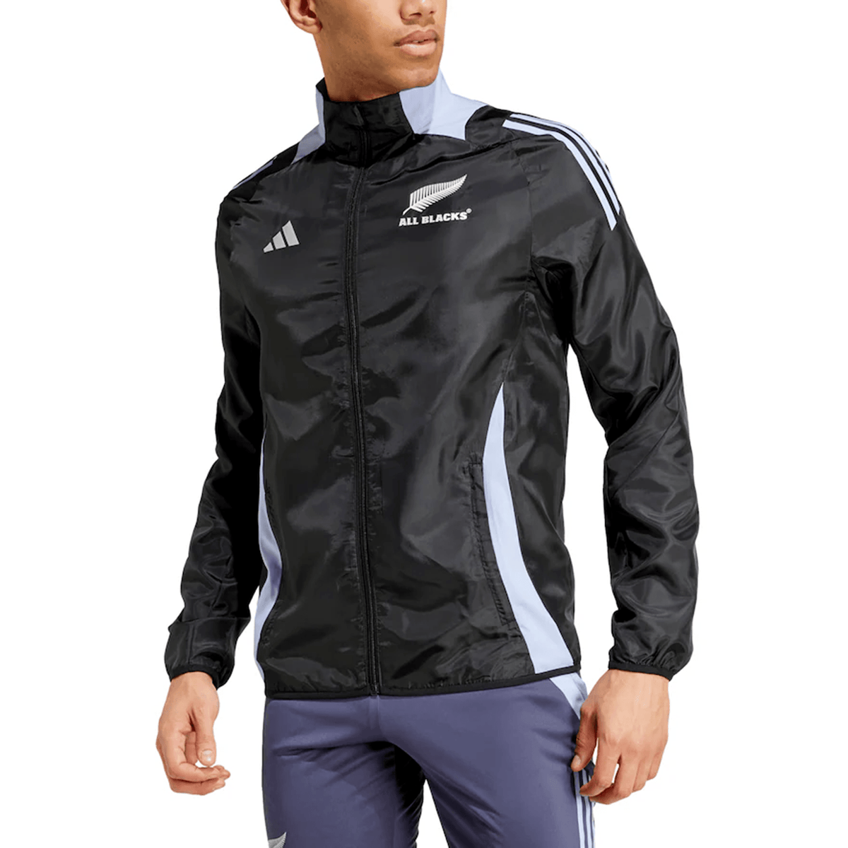 Person wearing an adidas All Blacks 24/25 Presentation Jacket by Adidas, showcasing the iconic silver fern with black, light blue, and white accents, paired with matching pants.