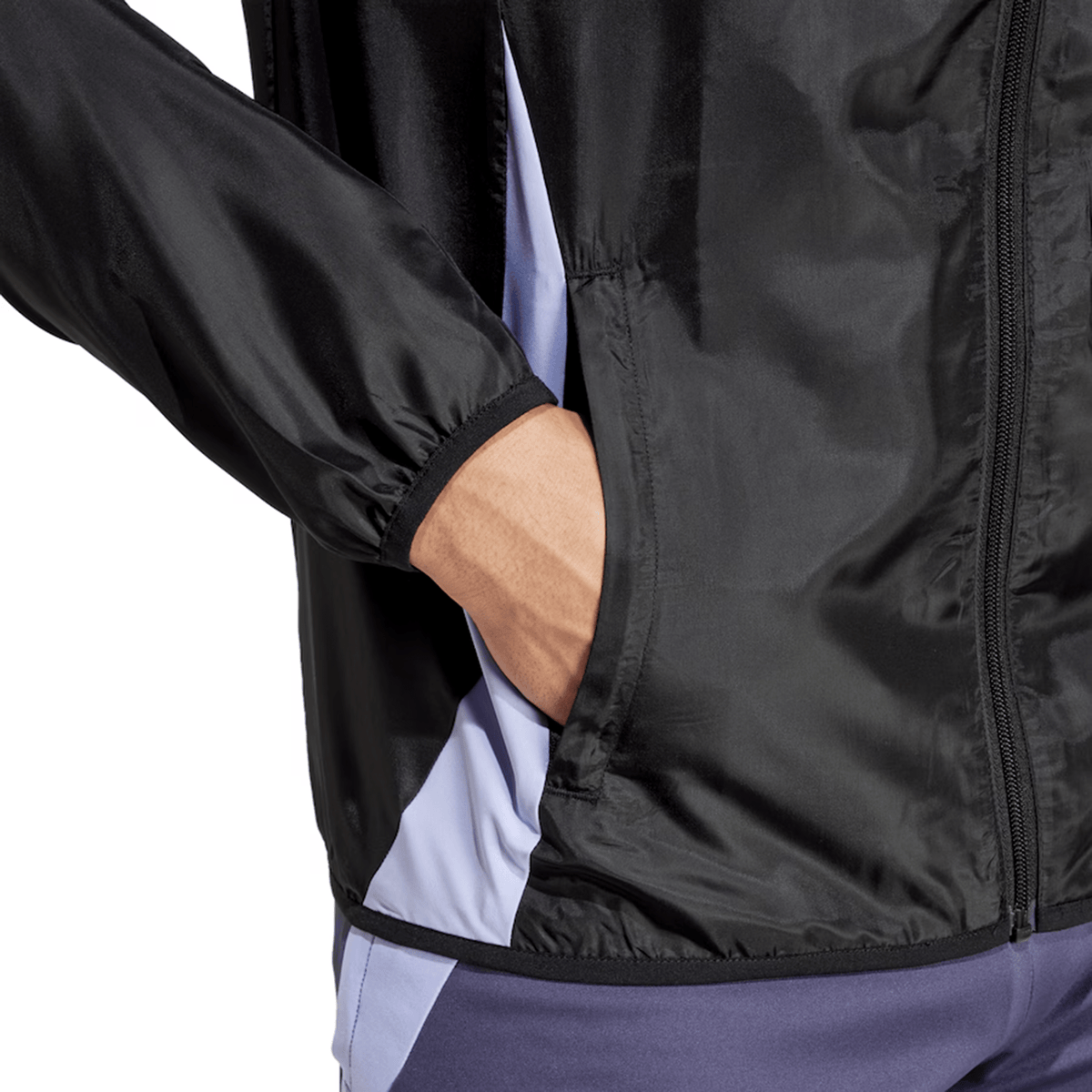 A close-up shows a person in the Adidas All Blacks 24/25 Presentation Jacket, featuring a black and gray design with one hand in the pocket, highlighting the intricate sleeve detail and side.