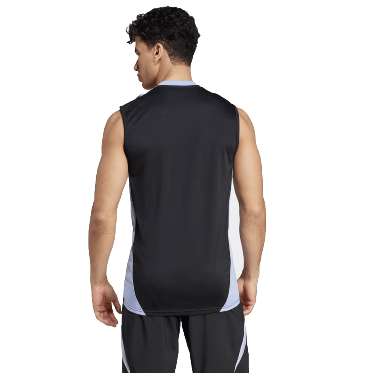 A man stands with his back to the camera, wearing the All Blacks 24/25 Performance Singlet by Adidas, a sleeveless athletic shirt in black and white.