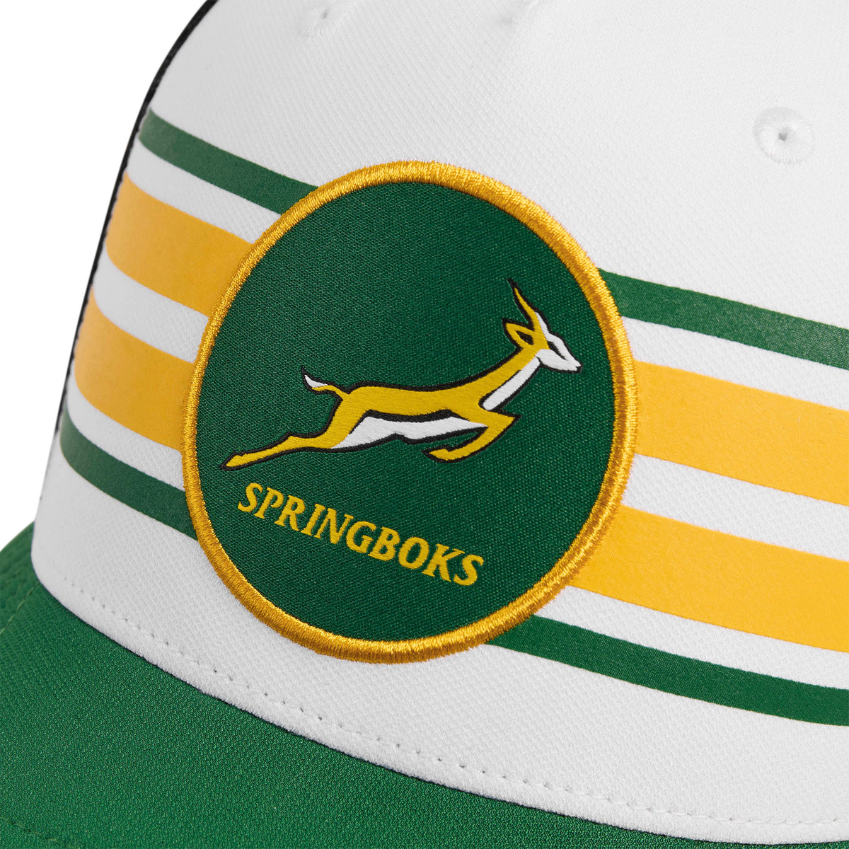 A close-up of a white and green Nike Springboks Trucker Heritage Rugby Cap featuring the embroidered Springboks logo.