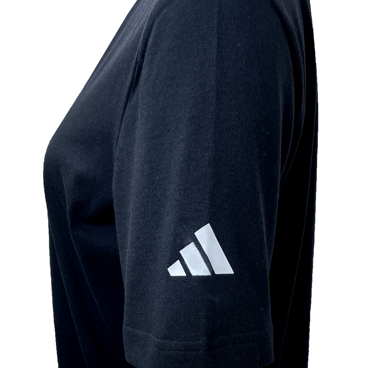 Close-up of a person wearing the Black Ferns Logo Tee by adidas, featuring a sleek white geometric logo on the left sleeve.