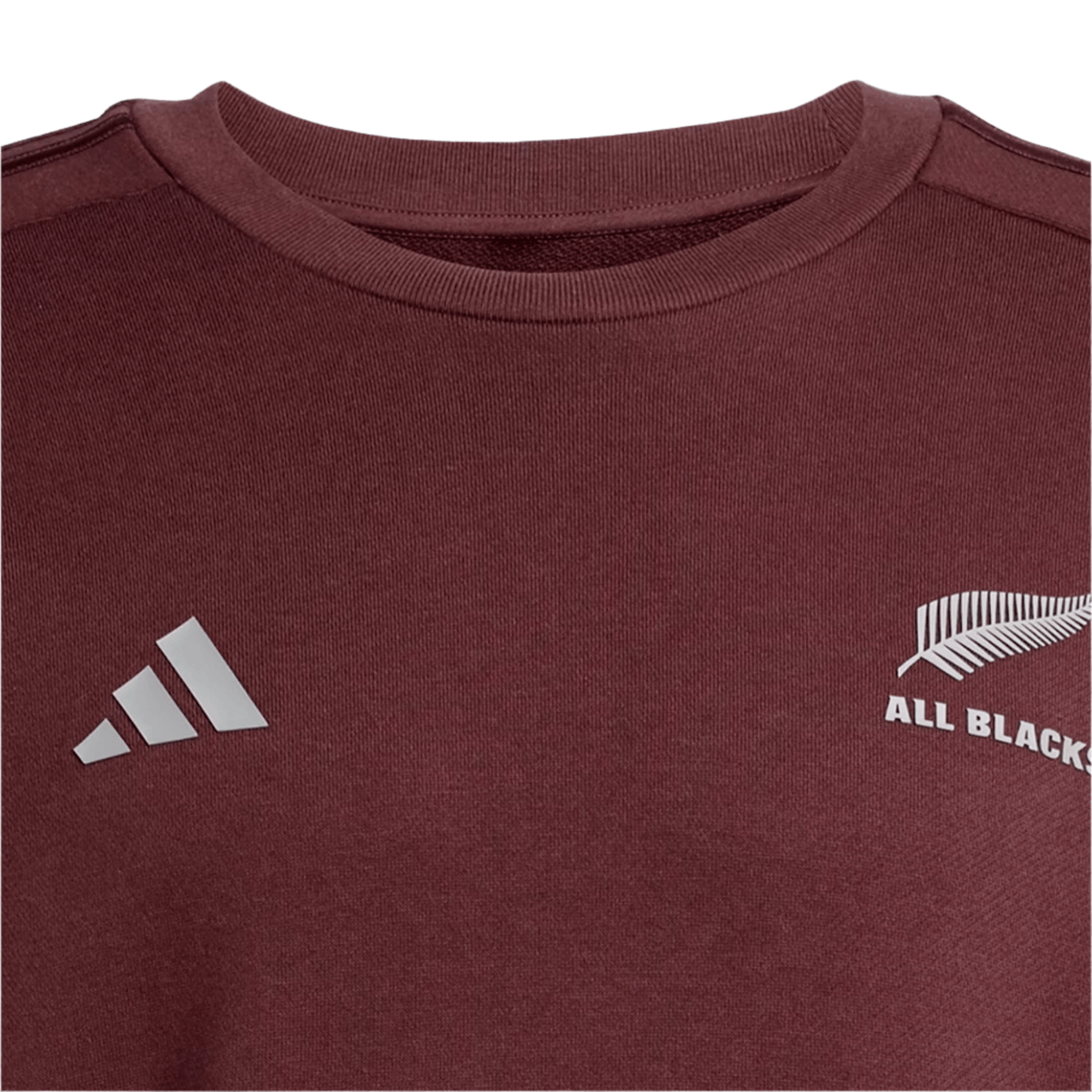 Maroon All Blacks 24/25 Fan Crewneck Sweatshirt by adidas features a silver fern and "ALL BLACKS" on one side, with a white Adidas logo on the other.