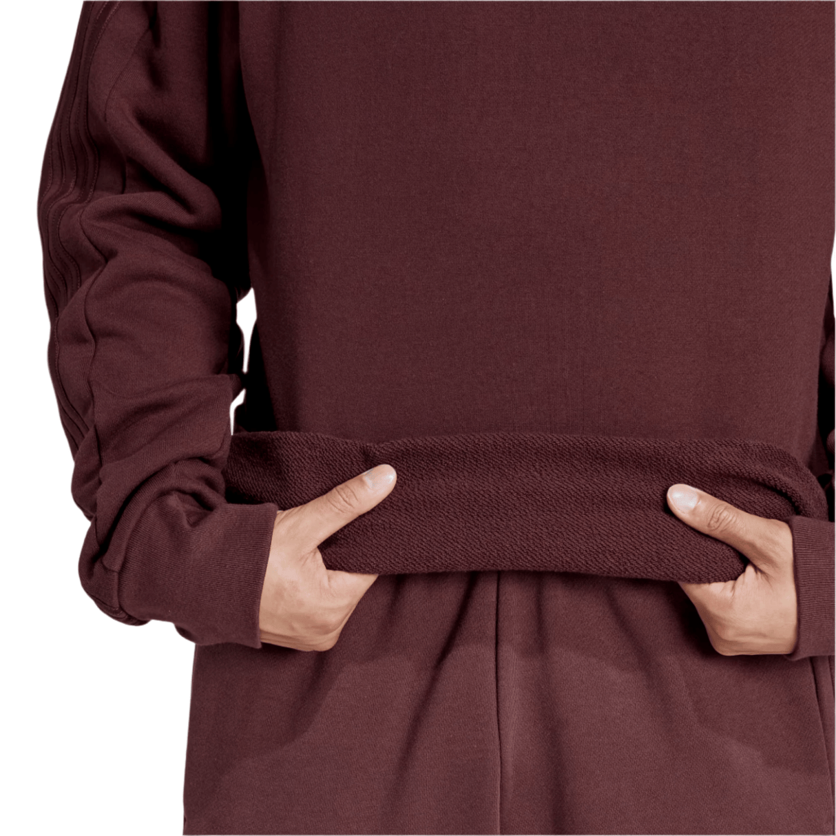 A person wearing the adidas All Blacks 24/25 Fan Crewneck Sweatshirt, maroon with long sleeves, hands casually in the front pocket.