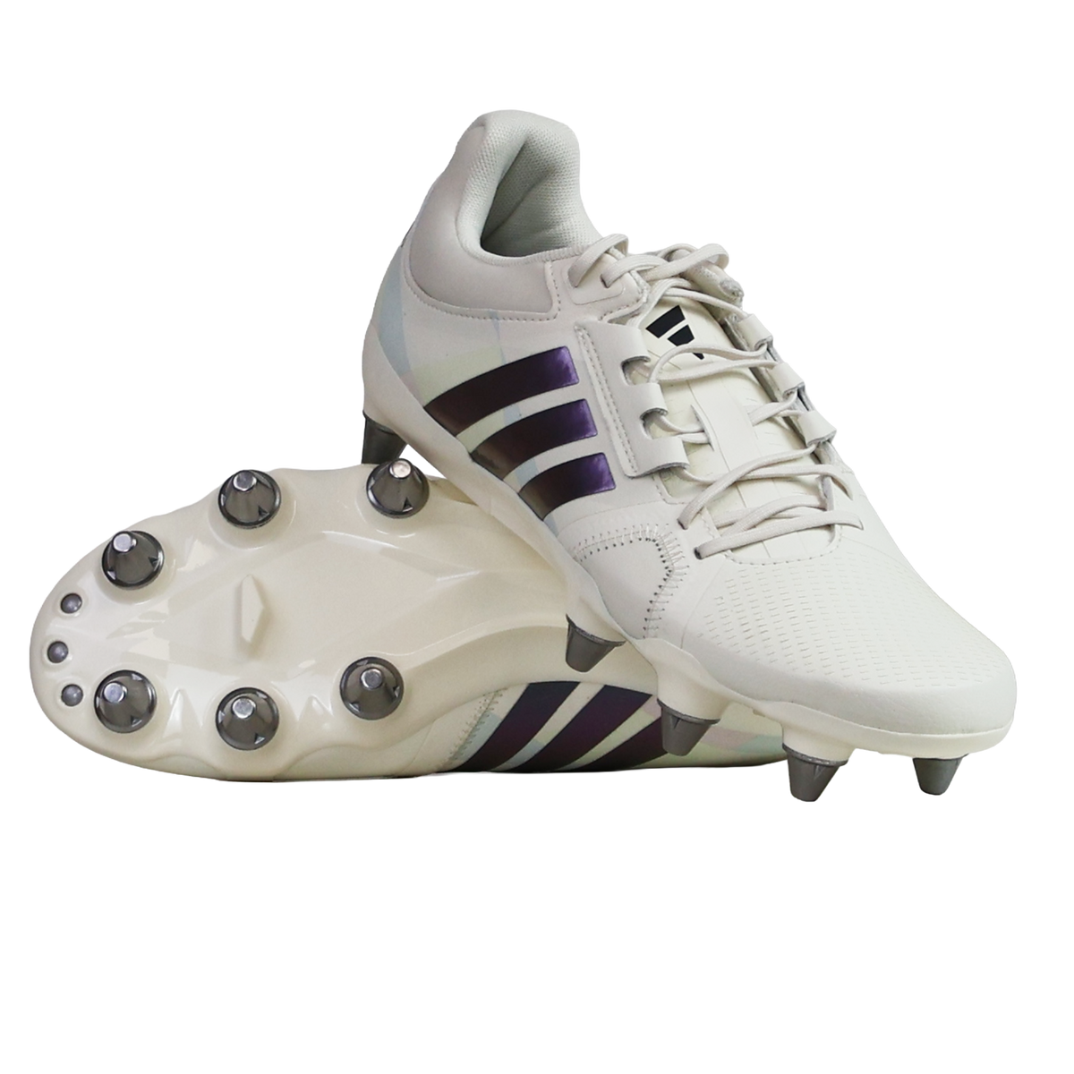A pair of women's adidas Kakari Avaglide SG rugby boots in off white and grey five, featuring the classic adidas stripes—one boot upright and the other displaying the six metal stud sole—ideal for forwards who want superior grip and stability on soft ground.