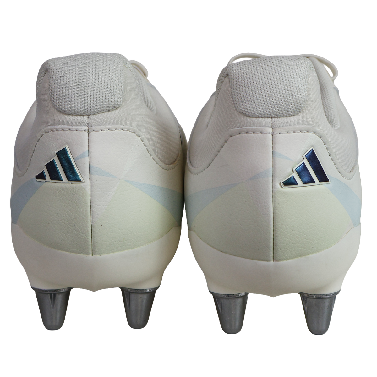 Back view of a pair of Women's adidas Kakari Avaglide SG rugby boots in Off White/Grey Five/Off White, featuring metal studs and an adidas logo on each heel, set against a plain white background.