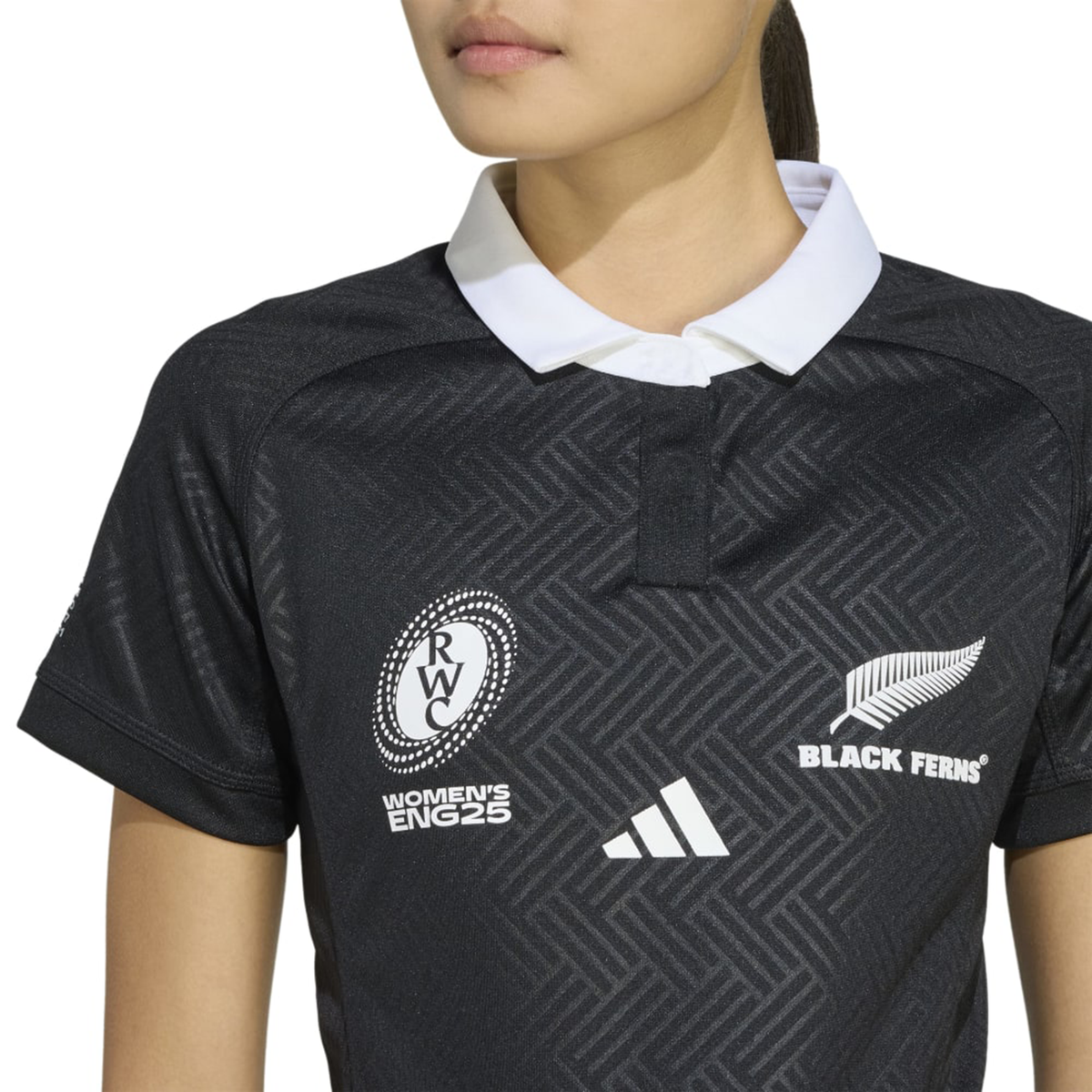Wearing the Women's Black Ferns WRWC25 Replica Home Jersey by adidas, featuring a white collar and Women's Rugby World Cup 2025 and Black Ferns logos—a true replica.