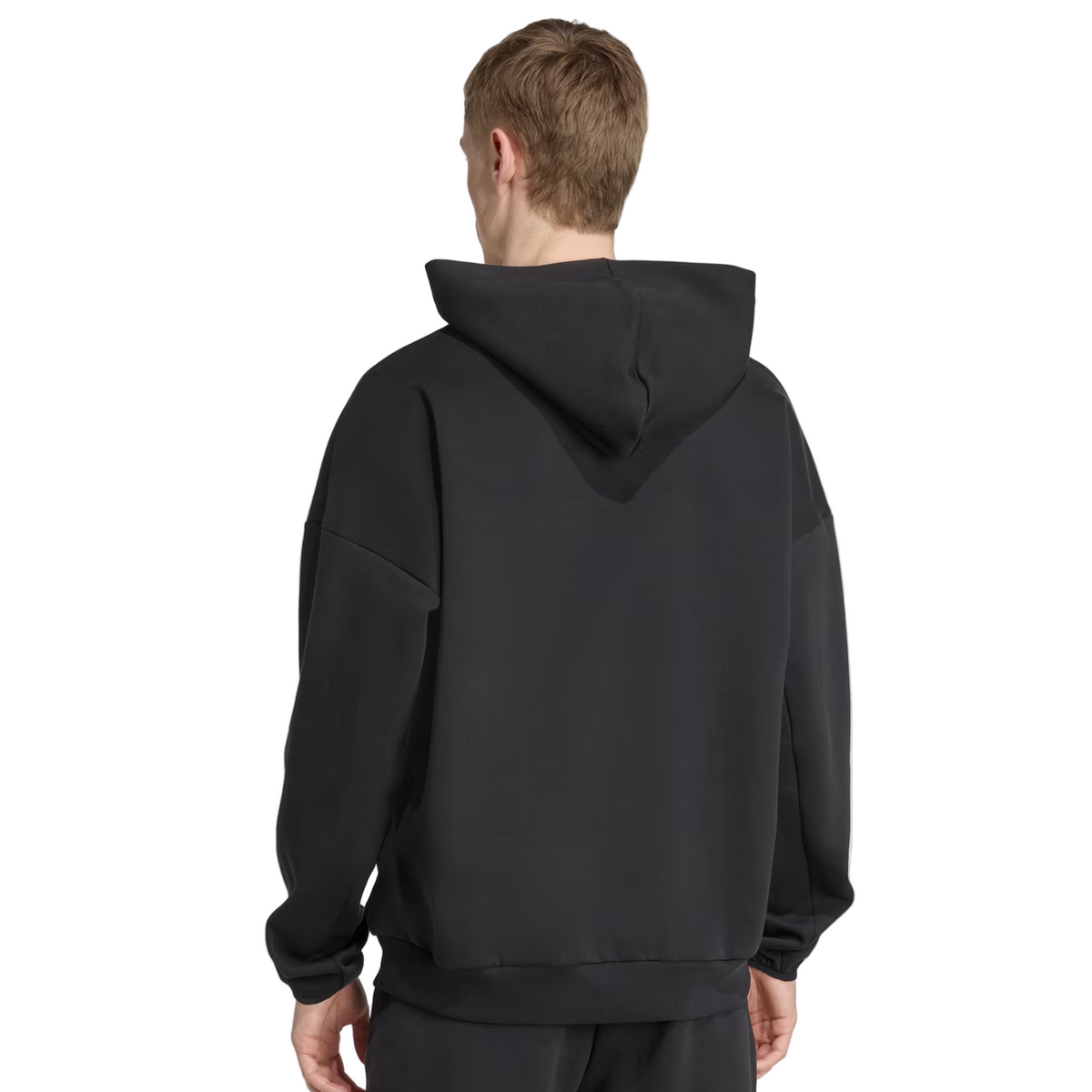 Someone wearing the adidas All Blacks 25/26 Presentation Hoodie stands facing away, displaying the back and hood of this adidas garment.