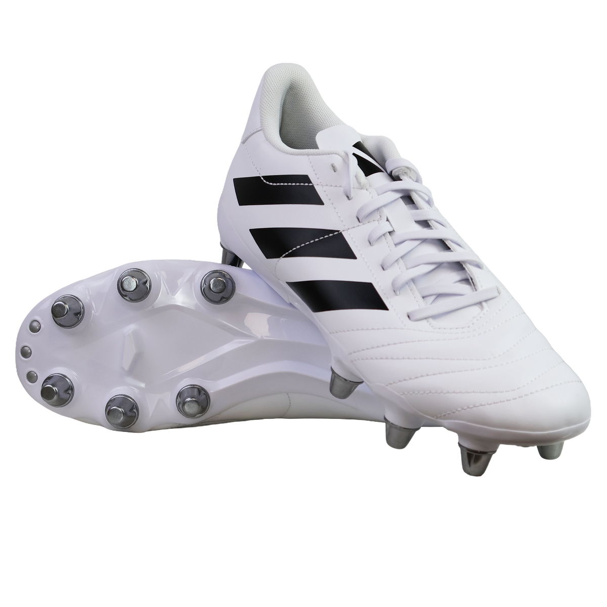 A pair of adidas Kakari SG rugby boots in White/Core Black/Silver Metallic, featuring black stripes and metal soft ground studs, are displayed—one upright and one showing the sole—against a plain white background.