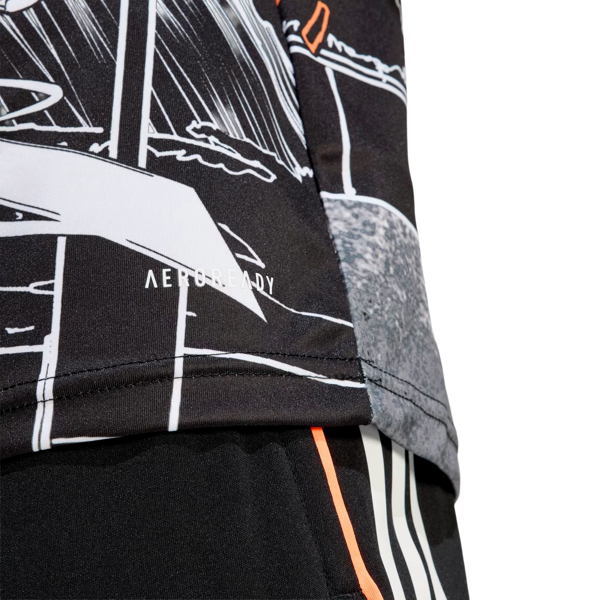 Close-up of the All Blacks 26/27 Captains Run Replica Jersey by adidas, showcasing a black and white graphic design with "AEROREADY" on the lower hem, paired with black shorts featuring bold orange and white stripes.
