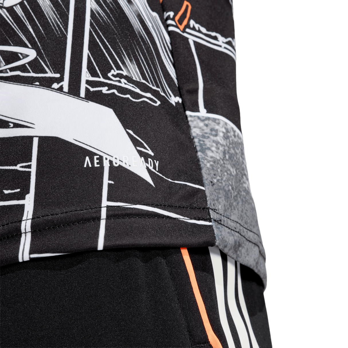 Close-up of the All Blacks 26/27 Captains Run Replica Jersey by adidas, showcasing a black and white graphic design with "AEROREADY" on the lower hem, paired with black shorts featuring bold orange and white stripes.