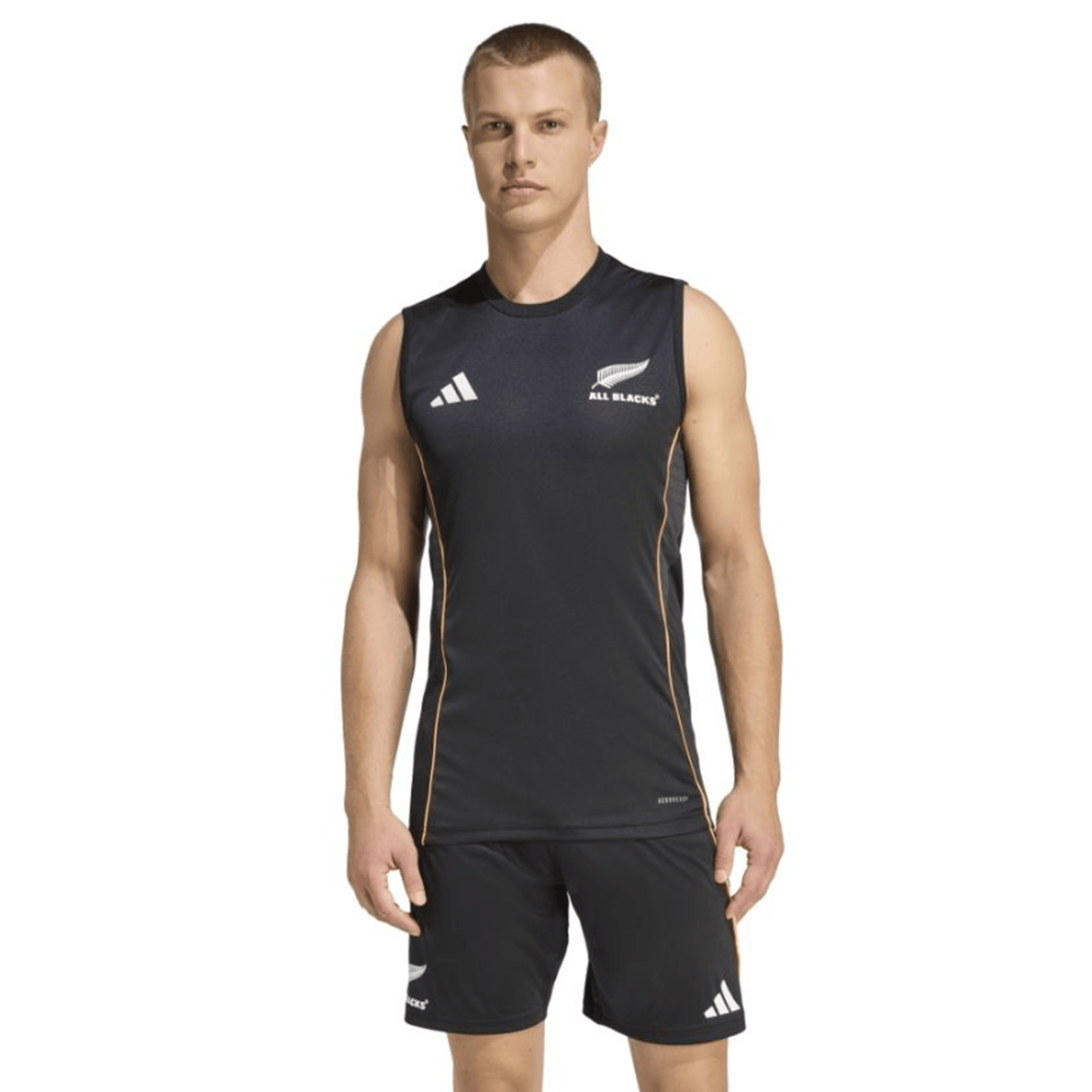 A man stands facing forward wearing the adidas All Blacks 26/27 Marvel Performance Training Singlet and matching black shorts against a plain white background.