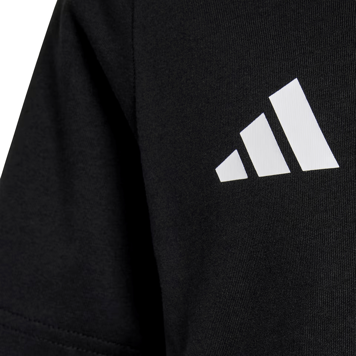 Close-up of black fabric with a white adidas logo and three diagonal stripes, from the All Blacks 26/27 Marvel Leisure Tee by adidas, celebrating New Zealand rugby.