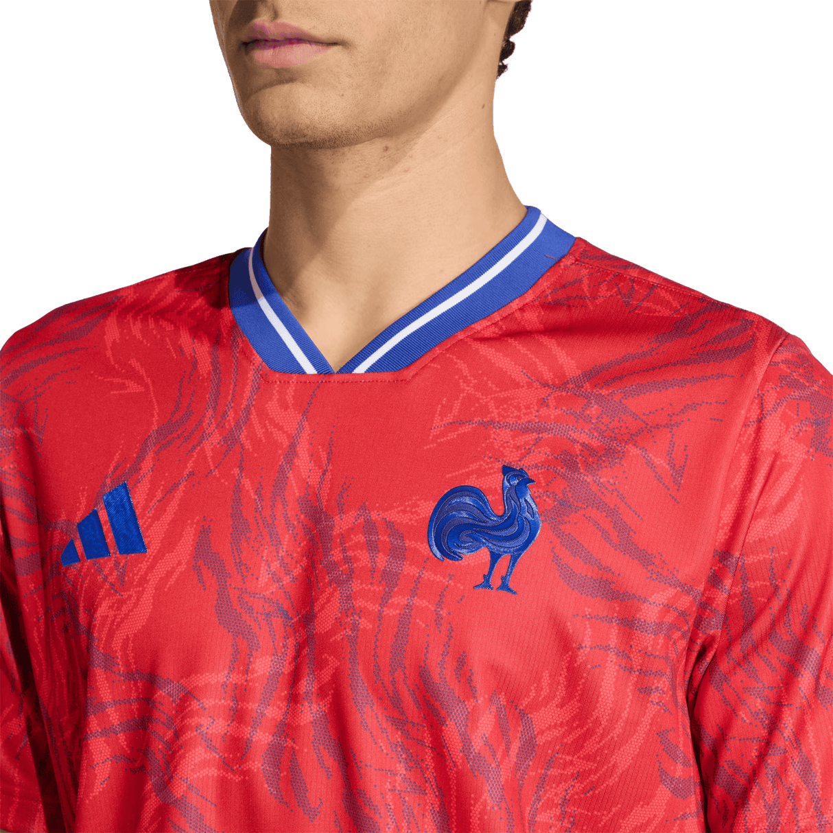 A person wearing the France Rugby Prematch Jersey by adidas, featuring blue accents, a blue rooster emblem, the adidas logo on the chest, and Climacool technology for enhanced comfort.