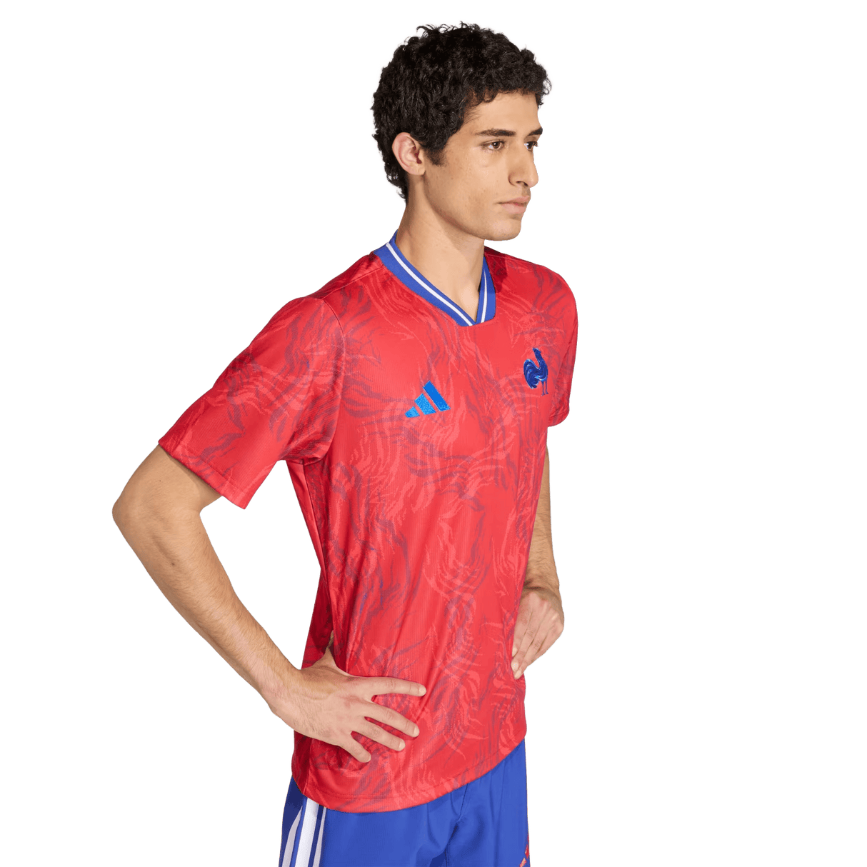 A man stands with hands on hips, wearing the adidas France Rugby Prematch Jersey featuring advanced Climacool technology for breathability and blue shorts, set against a plain white background.