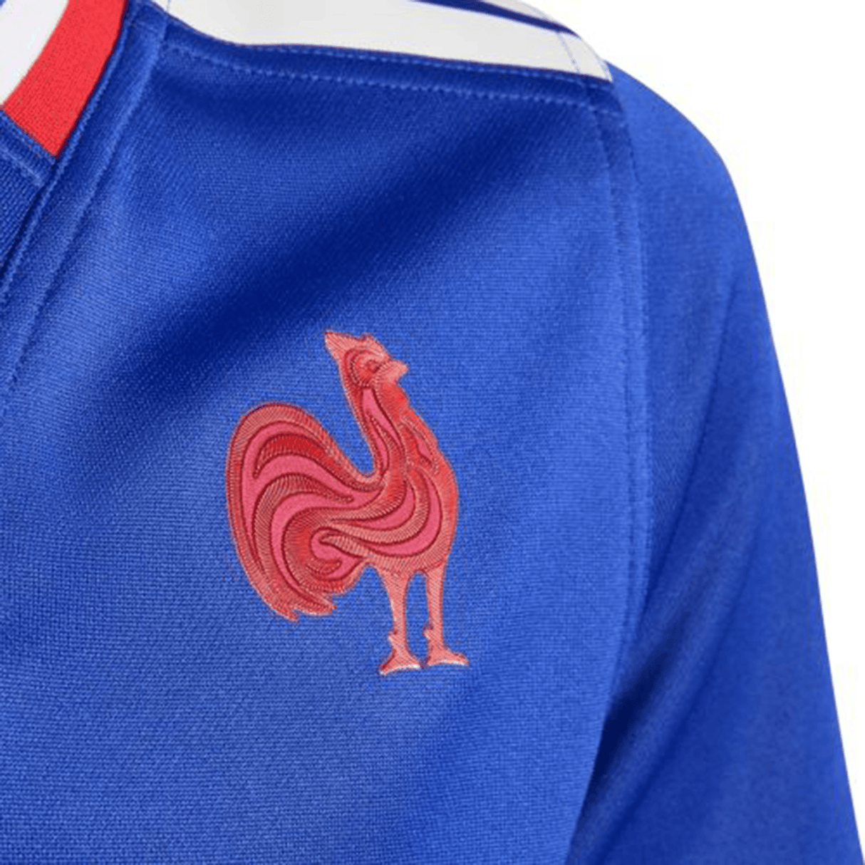 A close-up of the France FFR 25/26 Replica Home Jersey by adidas, showing its blue design with a red rooster emblem on the chest and white-red stripes near the collar.