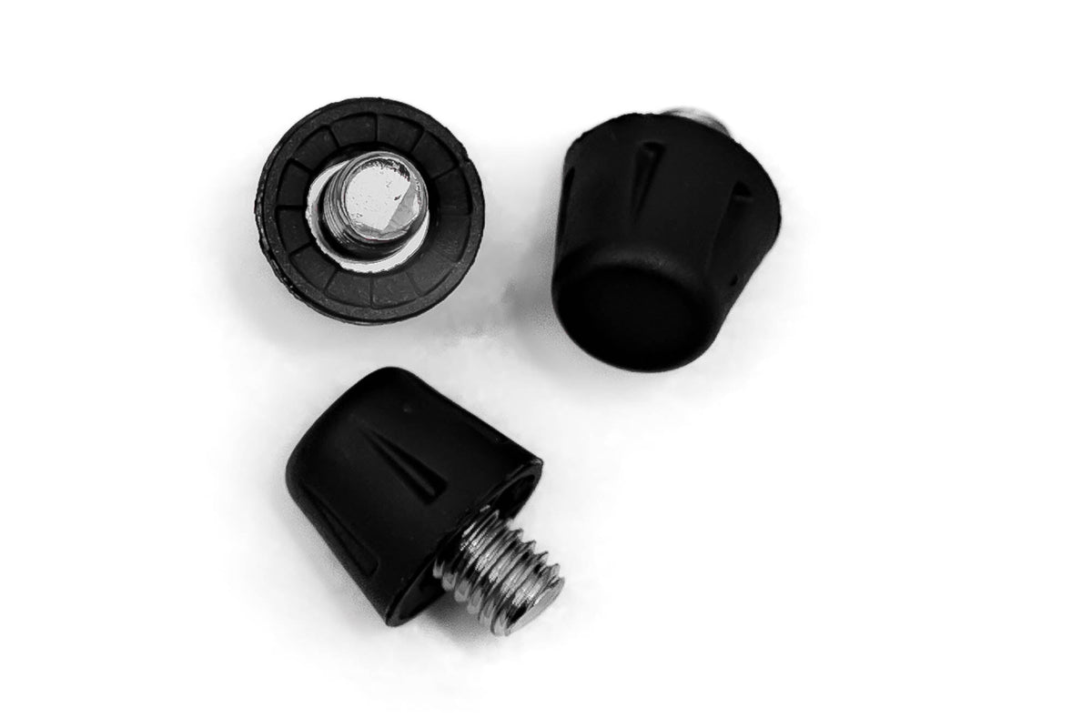 A pair of black plastic knobs on a Starlai Corp WRS All Surface/All Weather M6 Stud Kit on a firm/hard natural grass surface.