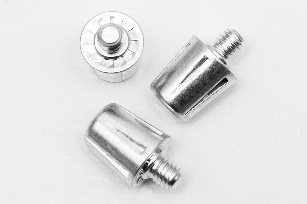 A pair of WRS All Surface/All Weather M6 Stud Kit screws firmly embedded in soft ground, made by Starlai Corp.