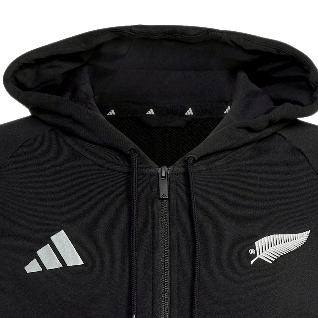 The All Blacks 26/27 Travel Full Zip Hoodie by adidas features a hood, adidas logo on the left, and white fern on the right—perfect for New Zealand rugby or All Blacks hoodie fans.