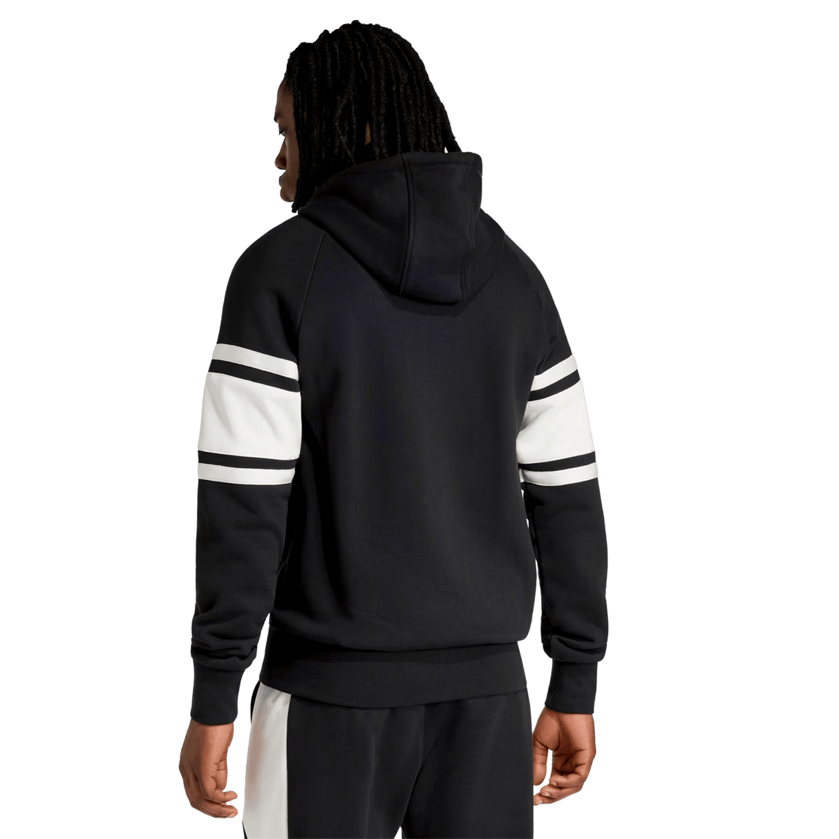 A person is seen from the back against a plain background, wearing the adidas All Blacks 26/27 Travel Full Zip Hoodie with white and black striped sleeves and black pants with a white stripe.