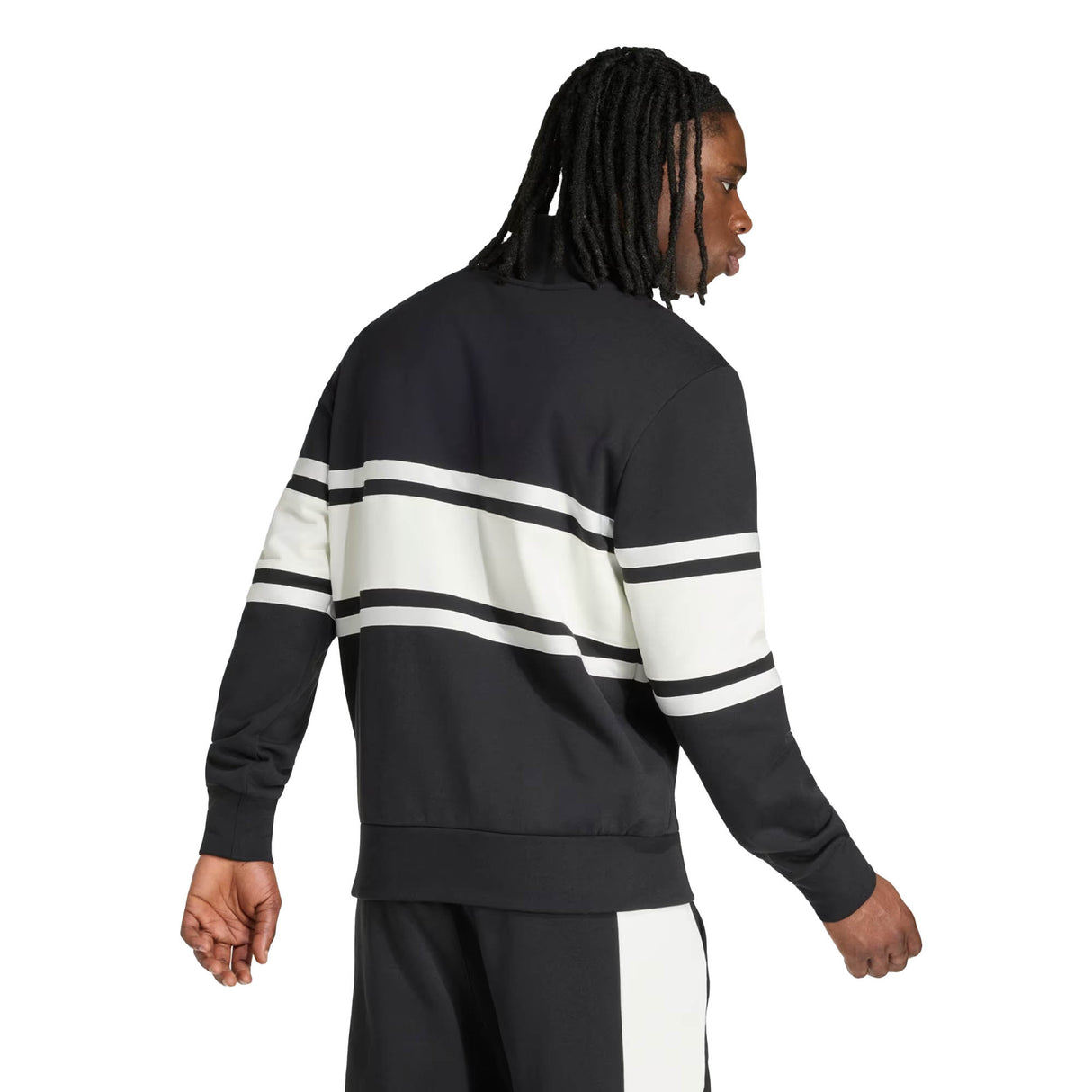 A man with long braided hair, facing away from the camera against a plain background, wears the All Blacks 26/27 Leisurewear 1/4 Zip Sweatshirt by adidas—a perfect showcase of New Zealand Rugby leisurewear styled with its black fabric and white and black horizontal stripes.