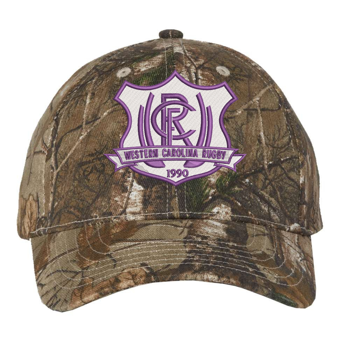 Western Carolina University Realtree Camo Cap featuring an adjustable fit and a purple and white shield emblem with “Western Carolina Rugby” and “1990” printed on it.