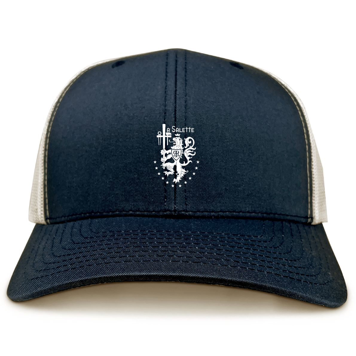 The La Salette Academy Rugby Retro Trucker Cap by EMB S&S Activewear features a navy blue and beige design, a white embroidered crest emblem with "Salette" on the front, and a classic snapback closure.