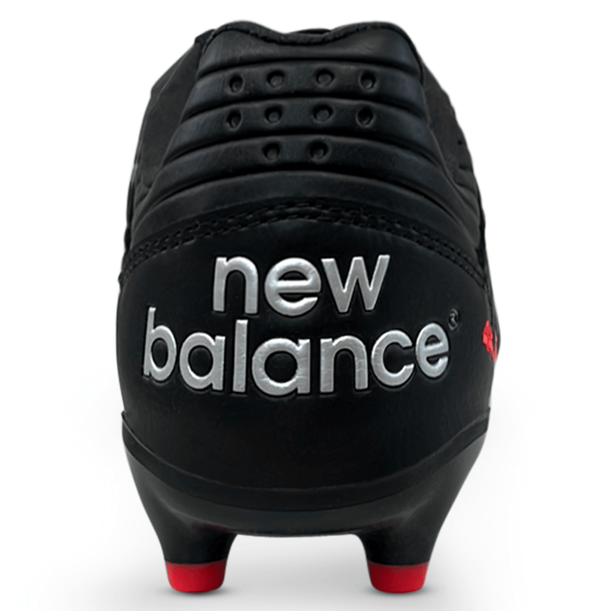 Close-up rear view of the New Balance Wide 442 V2 Pro Synthetic FG rugby boot in black and silver, featuring bold silver "new balance" branding and red-tipped studs.