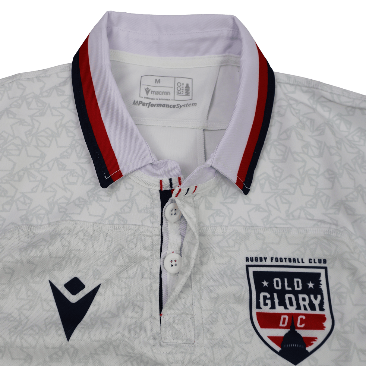 The Old Glory DC MLR 25/26 Replica Away Jersey by Macron features a red and navy collar, "Old Glory DC" crest on the right chest, Macron logo on the left, and a subtle geometric pattern for an authentic look.
