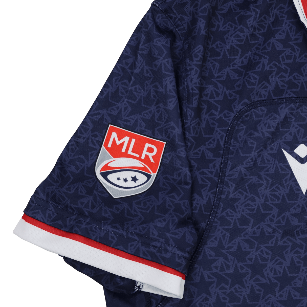 Close-up of the Old Glory DC MLR 25/26 Replica Home Jersey by Macron shows a navy sleeve with the MLR logo patch, red and white trim, and a subtle geometric pattern.