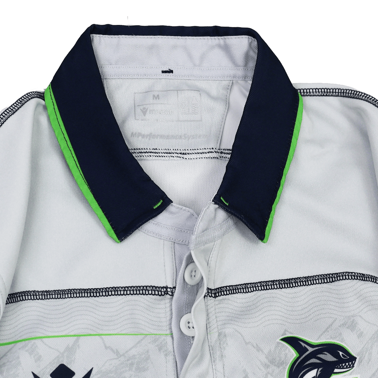 Close-up of the Seattle Seawolves MLR 25/26 Replica Away Jersey by Macron—a white collared sports shirt with dark blue and green trim, three buttons, and a dolphin logo on the right side.