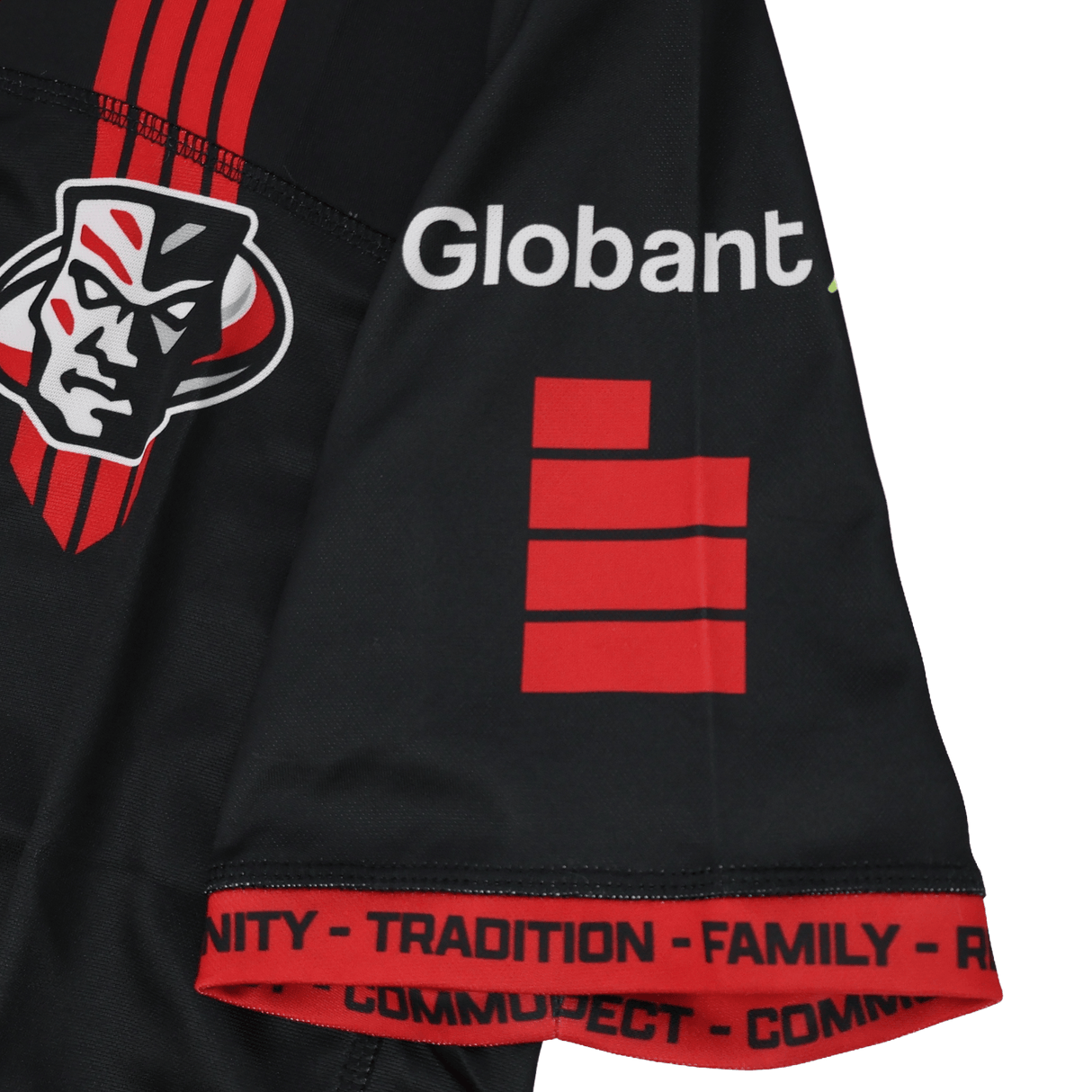 Close-up of the Utah Warriors MLR 25/26 Replica Home Jersey by Macron, featuring a black sleeve with a red stylized face logo, "Globant," red bars, and words like "TRADITION" and "FAMILY"—an iconic Major League Rugby look.