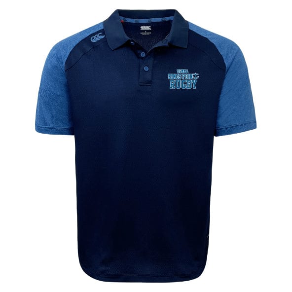 The King's Point Rugby Elite Polo by EMB Canterbury is a navy blue and light blue rugby polo shirt featuring moisture-wicking Vapodri fabrics and an embroidered logo on the chest.
