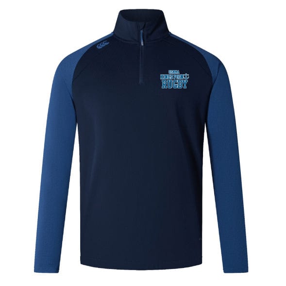 The King's Point Rugby Elite First Layer by EMB Canterbury is a navy and dark blue rugby pullover with a half-zip, incorporating VapoDri technology. It features "RFBA Teenage Rugby" text and a logo on the chest, making it perfect for rugby training sessions.
