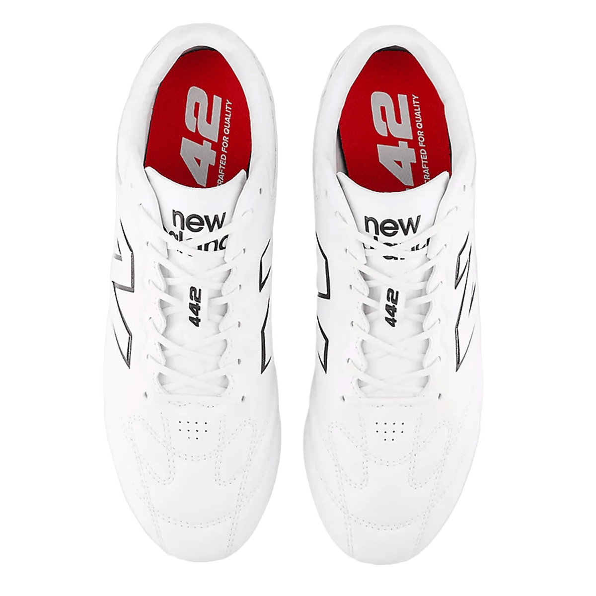 Top view of a pair of New Balance 442 Pro FG v3 Rugby Boots in white and black, featuring red insoles with the numbers “442” and the phrase “crafted for quality.” These firm ground boots are designed with a True Touch upper for superior control and comfort.