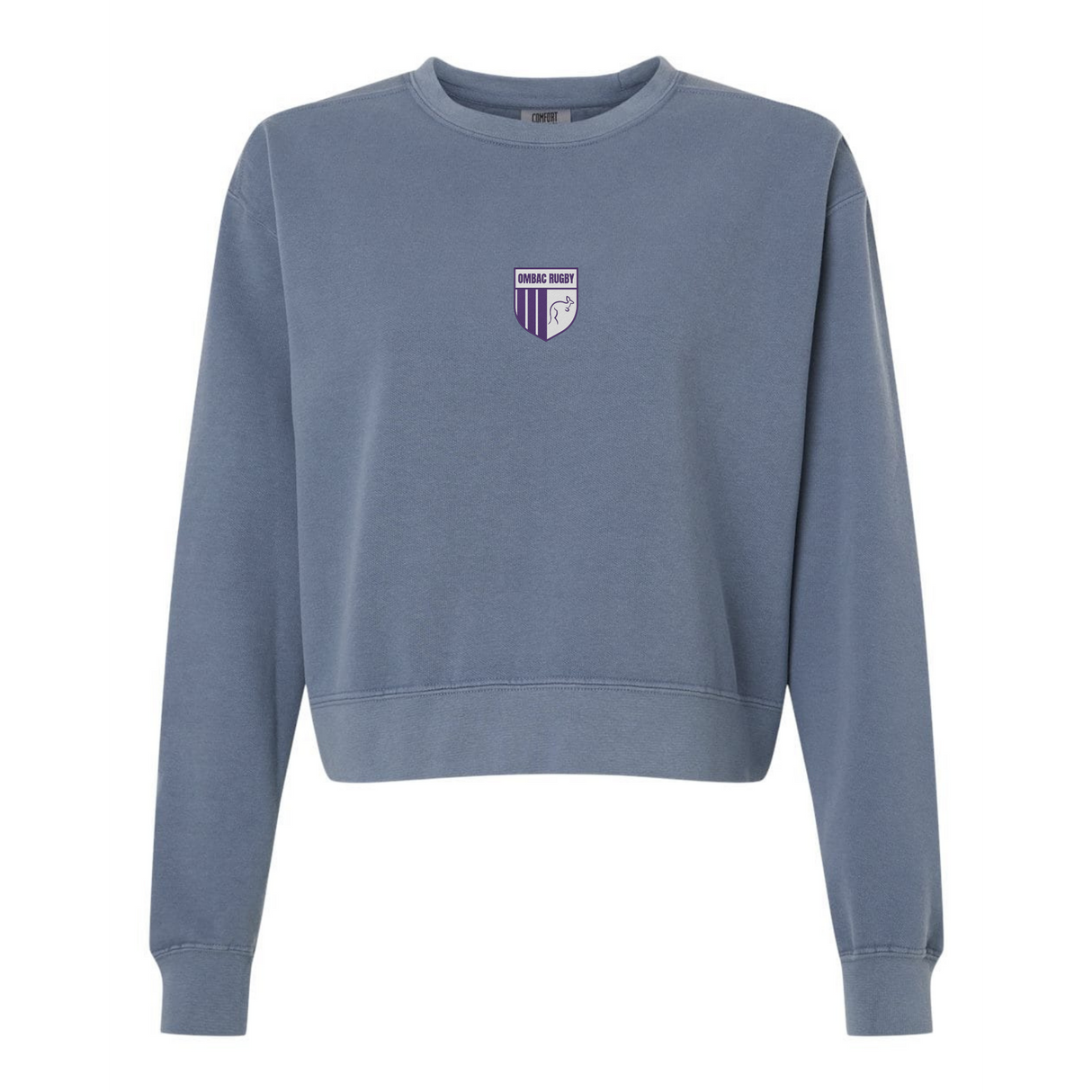 The Women's OMBAC Youth Rugby Mid-Length Crewneck Sweatshirt by EMB S&S Activewear is a blue, garment-dyed women's crewneck featuring a small purple and white shield logo with "Orange Rugby" on the left chest.