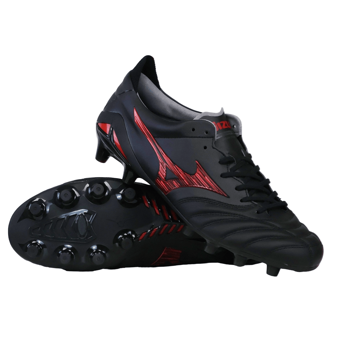 A pair of Mizuno Morelia Neo IV FG Made in Japan Rugby Boots in Black/Morelia 40th Anniversary Red, with one standing upright and the other lying on its side to display the studded sole, reminiscent of premium leather rugby boots and highlighting Mizuno’s signature Japanese craftsmanship.