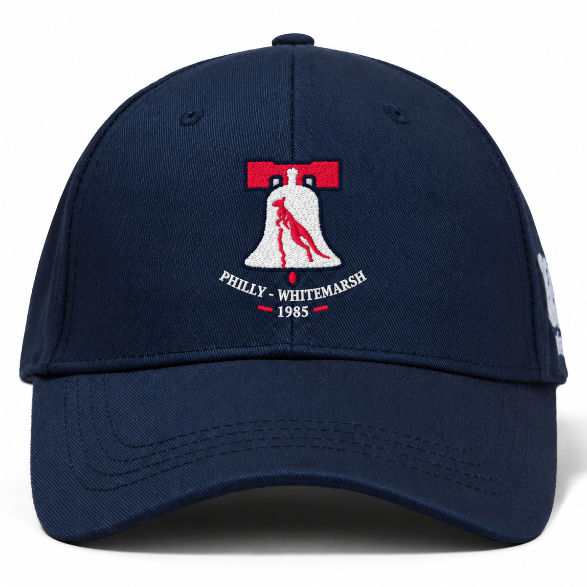 Navy blue Philly Whitemarsh RFC Flexfit Drill Cap by Canterbury featuring an embroidered emblem of a bell containing a kangaroo with the text “Philly - Whitemarsh 1985” underneath.