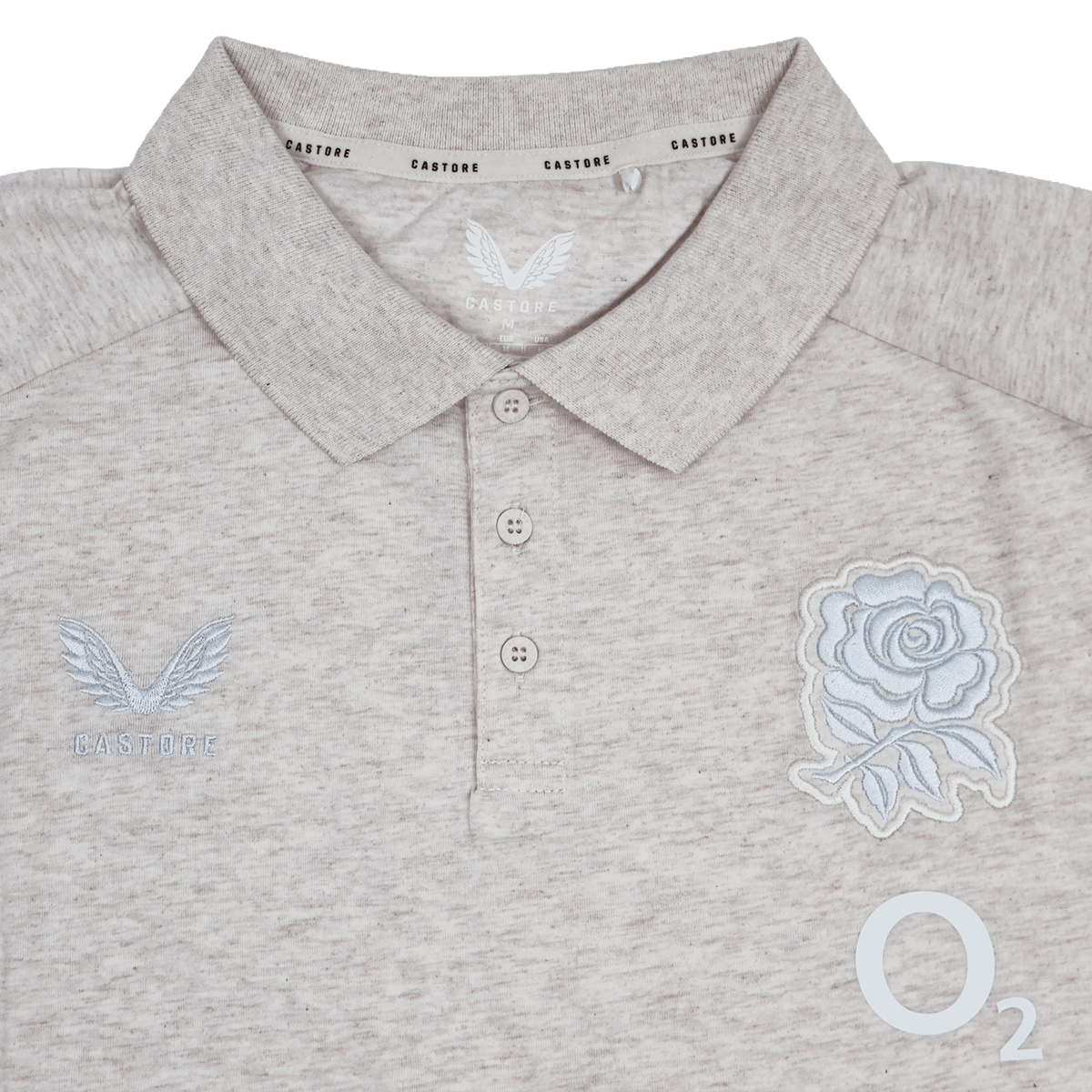 The England 26/27 Off-Pitch Polo by Castore features a beige design, three-button placket, rose emblem, Castore branding, and O2 logo—ideal for England Rugby fans looking for stylish off-pitch wear.