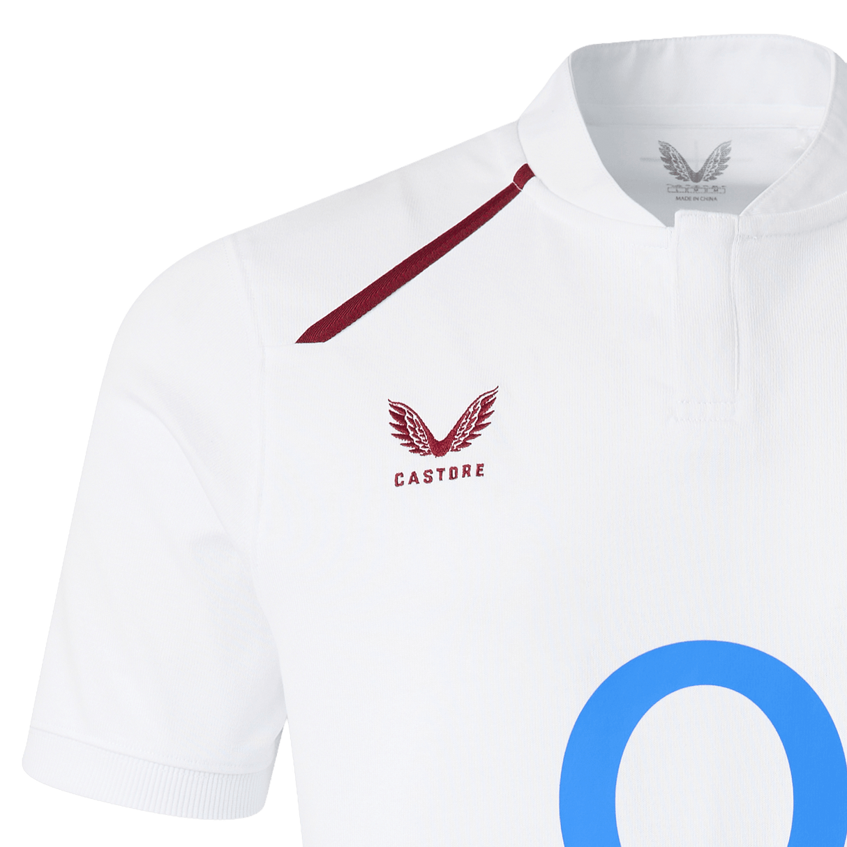 Close-up of the England 26/27 Classic Home Jersey by Castore, featuring a maroon winged logo, "Castore" text on the chest, blue "O" detailing, and a buttoned collar for a fresh update on the iconic look.