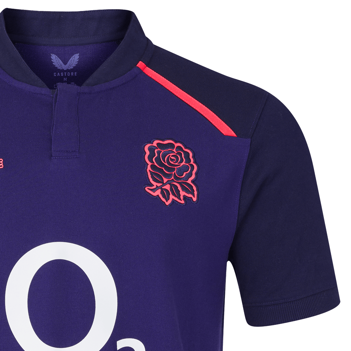 A close-up of the England 26/27 Classic Alternate Jersey by Castore in navy, showcasing the red rose emblem, red shoulder stripes, and a partial white "O2" logo—iconic elements from the Castore brand.
