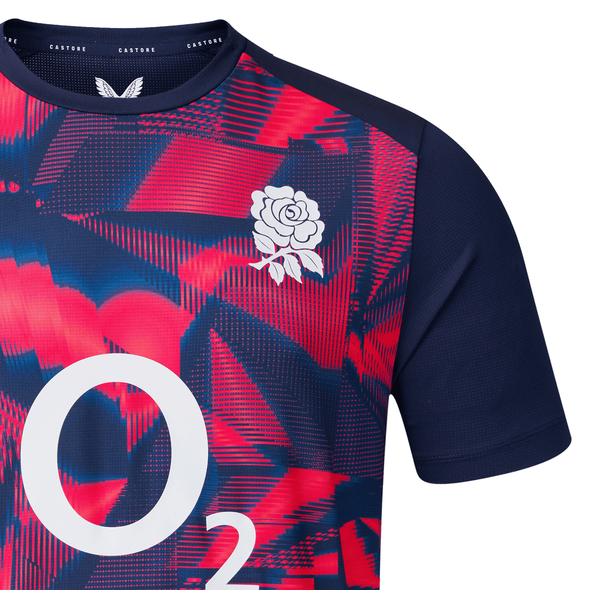 Close-up of the England 26/27 Pre-Match Top by Castore, displaying a red and blue geometric pattern, white rose chest emblem, and O2 branding.