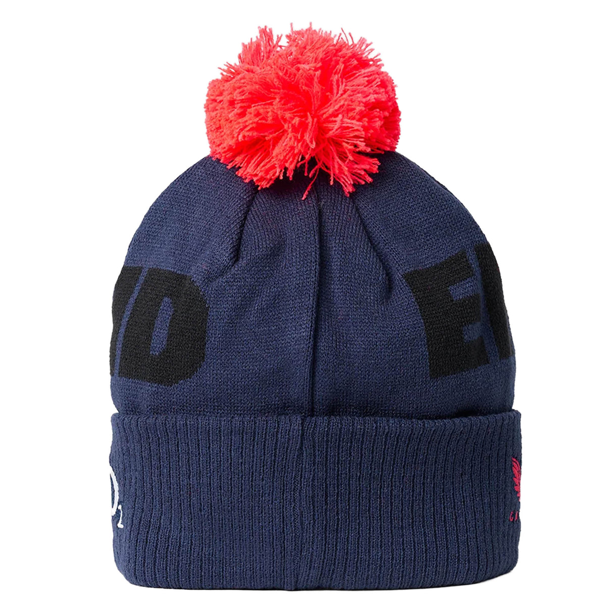 The England 26/27 Bobble Beanie by Castore is a navy blue knit hat featuring bold black lettering, a folded brim with a small Castore logo, and topped with a bright red pom-pom—making it the perfect winter accessory for any England supporter.