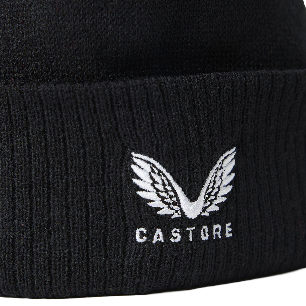 Close-up of the England 26/27 Bobble Beanie by Castore, a black knit beanie featuring a white winged embroidered Castore logo above the front text. This stylish winter accessory is perfect for England rugby supporters.