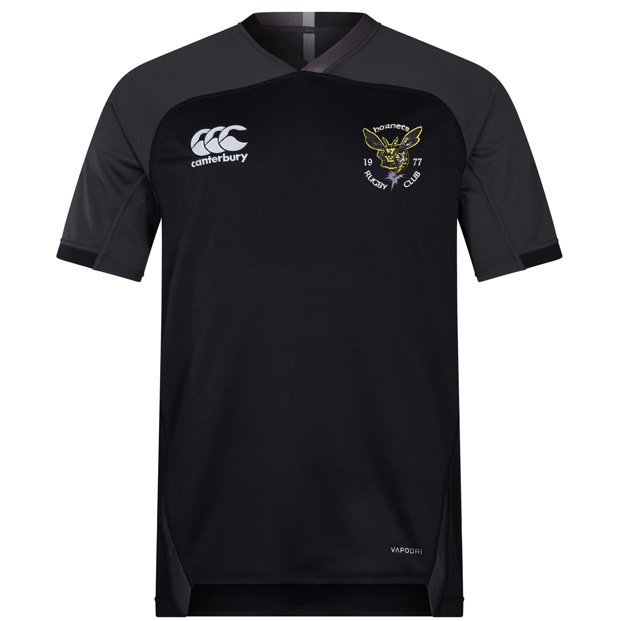Short-sleeved black Hornets Rugby Club 1977 Vapodri Evader Jersey by EMB Canterbury, featuring grey shoulders and moisture-wicking Vapodri fabric for enhanced comfort. The jersey includes the EMB Canterbury logo on the right chest and a hornet emblem with "Hornets Rugby Club 1977" on the left chest.
