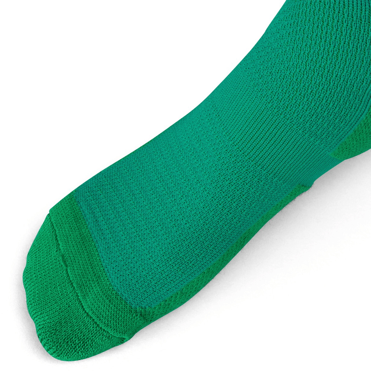 A close-up of a person's foot wearing Canterbury Ireland Home Socks by Canterbury against a white background.